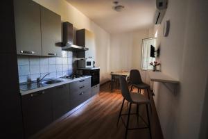 A kitchen or kitchenette at San Martino Holiday Apartments