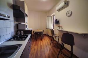 A kitchen or kitchenette at San Martino Holiday Apartments