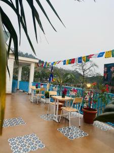 a patio with a table and chairs and flags at Karma Stay 2BHK apartments in Jaigaon