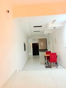 a dining room with red chairs and a table at Hotel Tulip Inn, Gulberg in Lahore