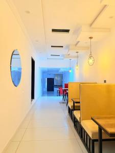 a dining room with a table and benches and a dining room at Hotel Tulip Inn, Gulberg in Lahore