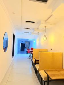 a dining room with benches and tables in a restaurant at Hotel Tulip Inn, Gulberg in Lahore