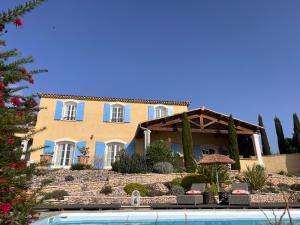 a house with a pool in front of it at La Bastide de Grosille in Savasse