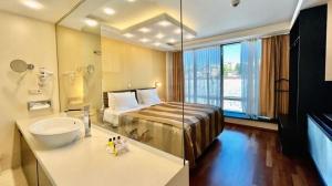 a hotel room with a bed and a sink and a bathroom at City Boutique Hotel in Sarajevo +37 photos