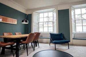 a dining room with a wooden table and chairs at Elegant 3BD Georgian Retreat in Perth City Centre in Perth +10 photos