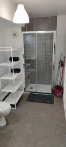 a bathroom with a glass shower with a toilet at l'incontournable Villepinte Parc des expositions in Villepinte