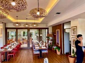 a man talking on a cell phone in a restaurant at Casa Cielo Baguio at Outlook Ridge Residences in Baguio