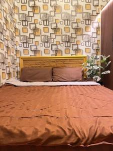 a bedroom with a bed and a wall with pictures at Airi Homestay in Suvarnabhumi Airport