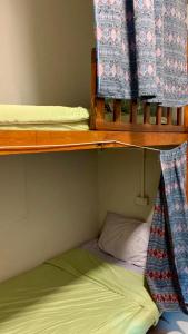 two bunk beds in a small room with a bed at Pakham hostel in Pai