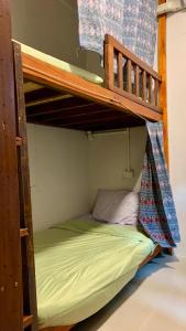 a bunk bed in a room with a green bed at Pakham hostel in Pai