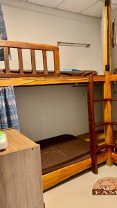 two bunk beds in a room with a table at Pakham hostel in Pai +1 photo