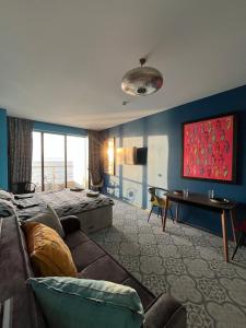 a hotel room with a bed and a couch at Bamboo Beach Tsikhisdziri Seaview Flat 838 in Tsikhisdziri +32 photos