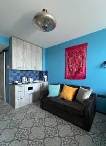 a living room with a couch in a kitchen at Bamboo Beach Tsikhisdziri Seaview Flat 838 in Tsikhisdziri