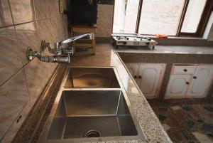 a kitchen with a sink and a counter top at Gyanman Homes in Kathmandu
