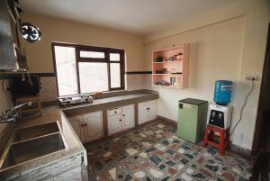 a kitchen with a green refrigerator and a window at Gyanman Homes in Kathmandu +15 photos