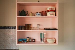 a shelf with various items on it in a bathroom at Gyanman Homes in Kathmandu