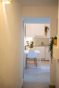 a kitchen with a table and a white table and chairs at Cozy Historical Nest in Naples