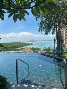 a swimming pool with a view of the water at Georgetown Ins Cozy Suites 2BR in George Town