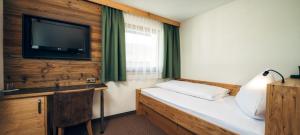 Postel nebo postele na pokoji v ubytování Hotel Barbara