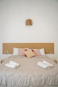 a bedroom with a large bed with two towels on it at Cozy Historical Nest in Naples