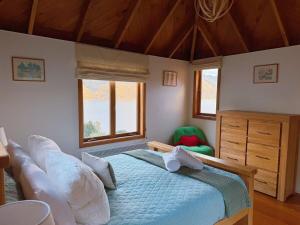 a bedroom with a bed with white pillows at Majestic Waters in Queenstown
