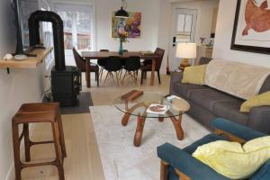 a living room with a couch and a wood stove at The Harbour House Montague in Montague