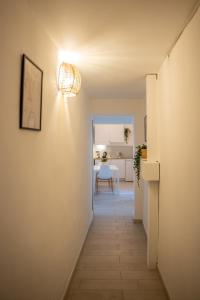 a hallway leading to a kitchen and a dining room at Cozy Historical Nest in Naples +12 photos