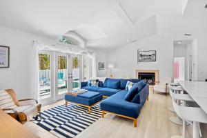 a living room with a blue couch and chairs at Little Pink Houses in Anna Maria