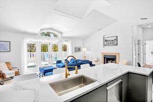 a kitchen with a sink and a living room at Little Pink Houses in Anna Maria +32 photos