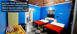 Letto o letti in una camera di Mysuru-hotel