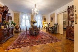 a living room with a table and a dining room at King's Royal Apartments in City Centre in Prague +23 photos