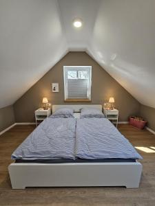 a bedroom with a bed with two night stands at Ferienhaus Mühle 7 in Krummhörn