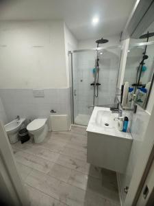 a bathroom with a toilet and a sink and a shower at VVR6 Apartment by Homes in Ancona in Ancona +23 photos