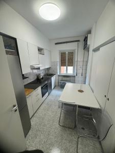 a kitchen with a white table and a table and chairs at VVR6 Apartment by Homes in Ancona in Ancona