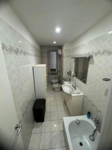 a bathroom with a sink and a toilet and a sink at VVR6 Apartment by Homes in Ancona in Ancona