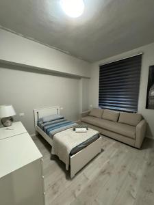 a living room with a bed and a couch at VVR6 Apartment by Homes in Ancona in Ancona