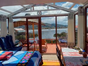 a bedroom with a view of the water at Wiñay UTA lodge in Puno