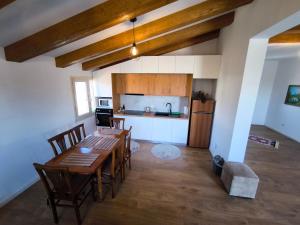 a kitchen and dining room with a table and chairs at Albanian Traditions Legacy in Durrës