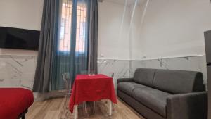 a living room with a couch and a table at Giudei House Torri in Bologna