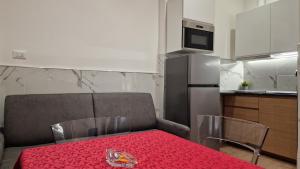 a kitchen with a table with a red table cloth at Giudei House Torri in Bologna +18 photos