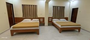 Postel nebo postele na pokoji v ubytování Hotel Tulsi