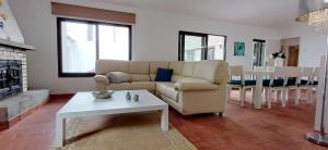 a living room with a couch and a table at Bonança Dunas Village in Fão