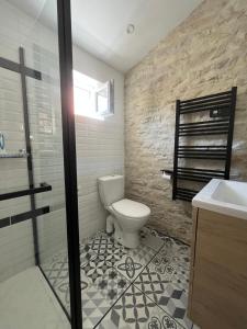 a bathroom with a toilet and a sink and a shower at Maison proche centre-ville in Dijon