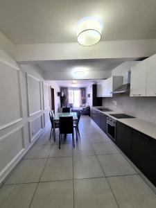 a kitchen and dining room with a table and chairs at Bay Water 21 in St. Julianʼs