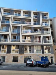 an apartment building with cars parked in front of it at Bay Water 21 in St. Julianʼs