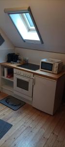 a kitchen with a stove and a window at Fewo Altmühle in Altlengbach