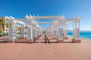 a pavilion on a beach with the ocean in the background at Côte d'Azur Oasis Suites in Nice