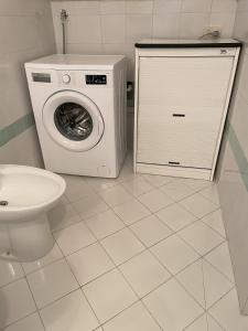 a bathroom with a washing machine and a toilet at Ischia Casareccia in Serrara Fontana +9 photos