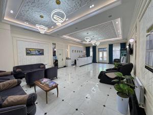 a large living room with couches and a table at Muxlis Hotel in Tashkent