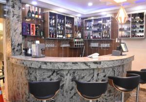 a bar in a restaurant with chairs around it at Grand Diamond Hotels & Suites LTD in Owerri